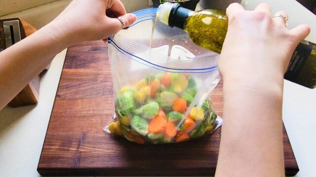 Adding Benissimo oil to chopped veggies