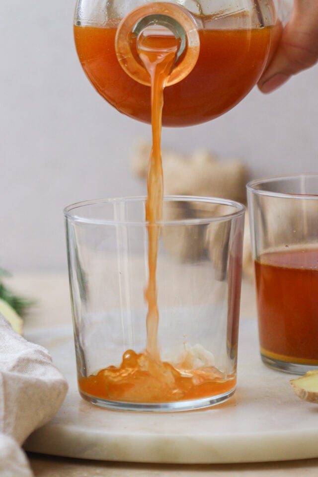 Pouring Fire Cider in a glass