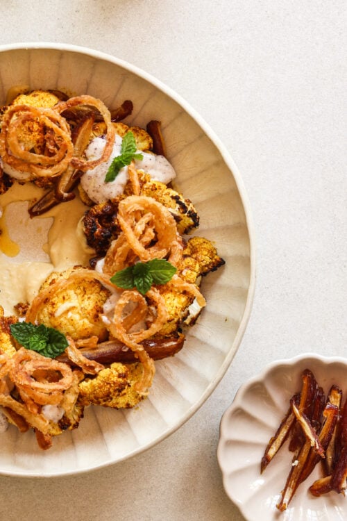 Moroccan-spiced cauliflower salad with hummus, dates, and a coconut yogurt dressing