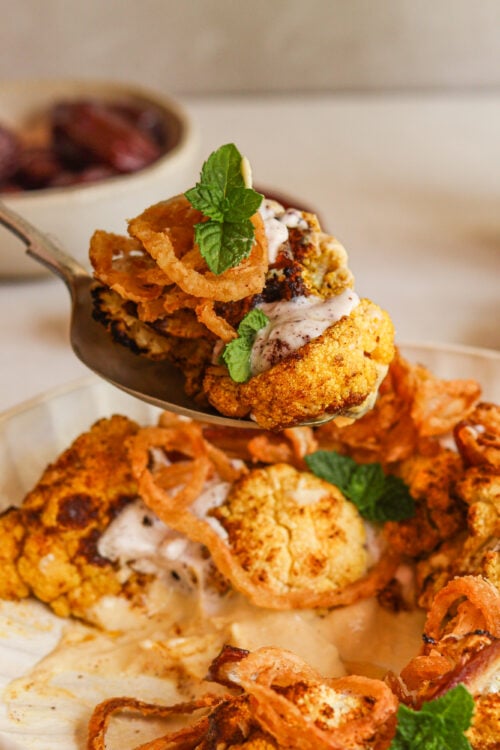 Moroccan-spiced cauliflower salad with hummus, dates, and a coconut yogurt dressing