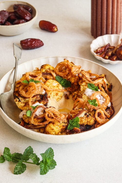 Moroccan-spiced cauliflower salad with hummus, dates, and a coconut yogurt dressing